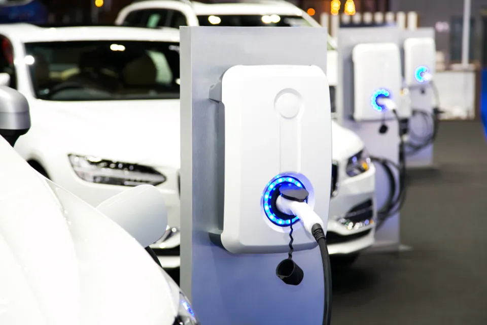 Row of white electric cars at charging station